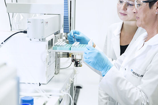 Performing food analysis in the laboratory: laboratory technicians during the examination for residues and contaminants