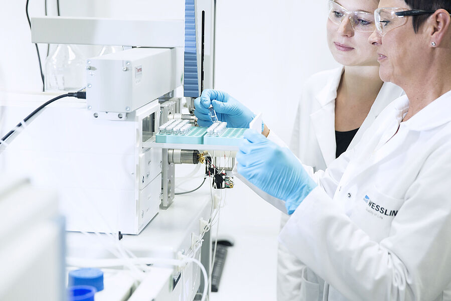 Performing food analysis in the laboratory: laboratory technicians during the examination for residues and contaminants