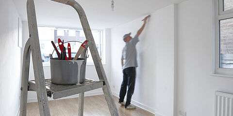 Painter painting a wall