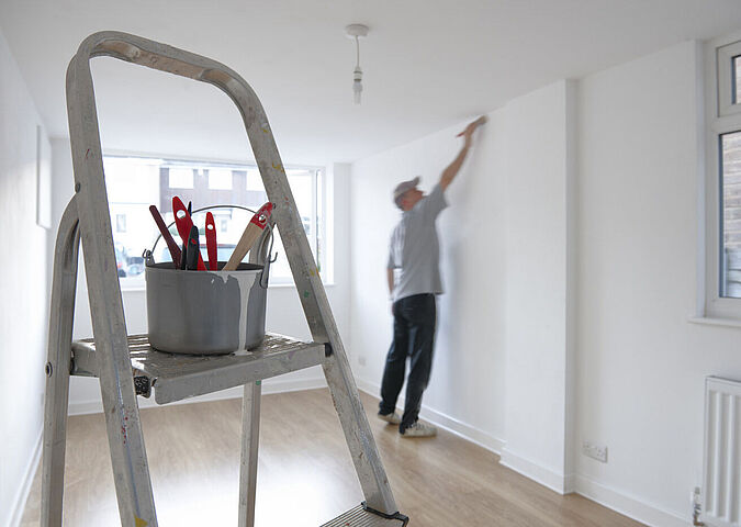 Painter painting a wall