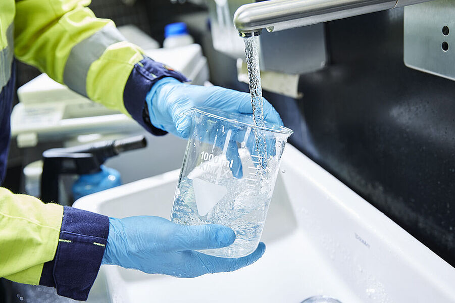 WESSLING takes a water sample