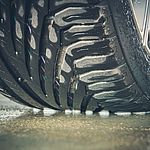 Car tyres on a wet road 