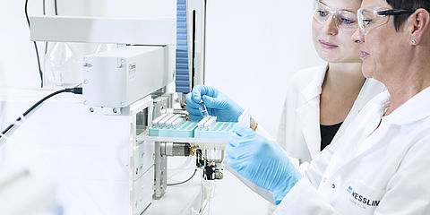 Performing food analysis in the laboratory: laboratory technicians during the examination for residues and contaminants