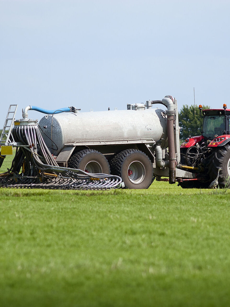 Tractor distributes organic fertilizer on a field